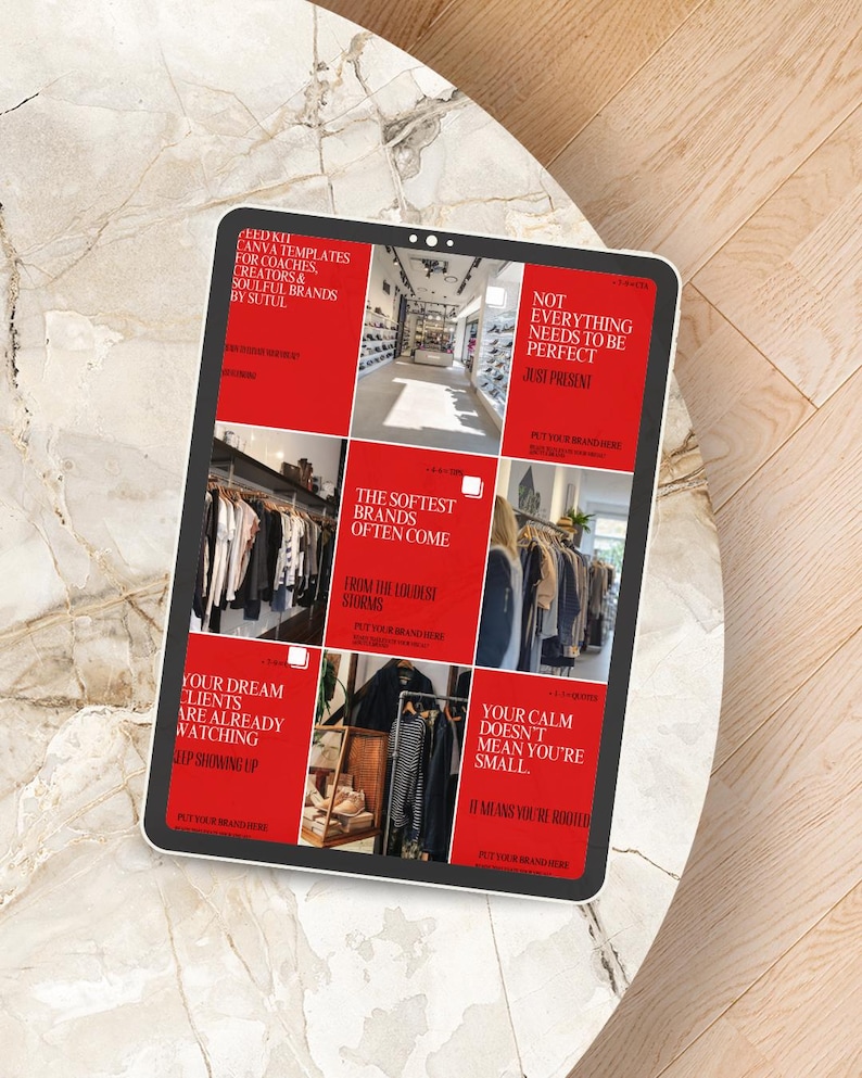 May include: A digital tablet displaying a grid of red squares with white text. The text includes phrases like "Feed Kit Canva Templates" and "Your Dream Clients Are Already Watching." The tablet is on a marble-patterned surface.