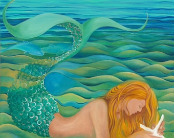 Redhead mermaid with aqua tail lying down admiring starfish in the blue green water