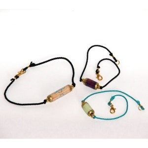 Sample photo - bracelets made with hand made paper beads and hand twisted pure silk cord.