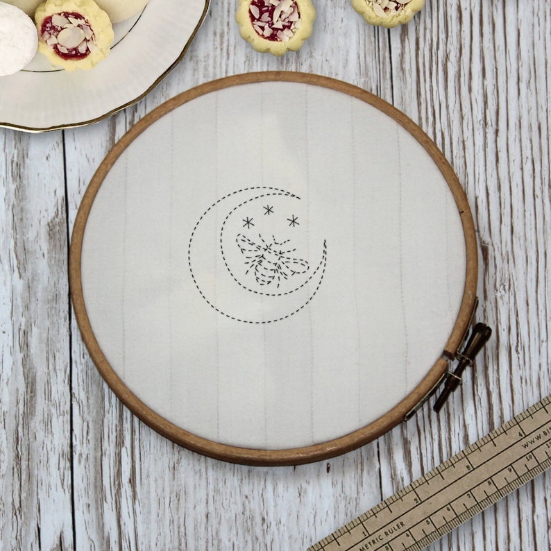 Bee and moon embroidery in an embroidery hoop