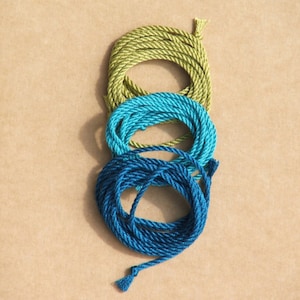 Photo of three silk cords in apple green, aqua and teal blue.