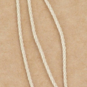 Pure silk cord strands showing twist and size.