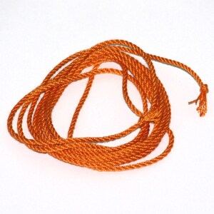Orange handmade pure silk cord (1mm) pack of two on white background.