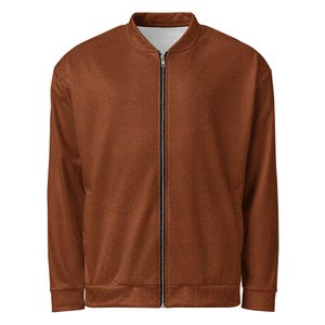 May include: A brown bomber jacket with a zipper closure. The jacket has a subtle pattern of small dots.