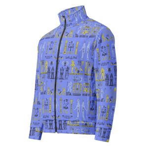 May include: A blue zippered jacket with a pattern of Egyptian hieroglyphs in yellow and black.