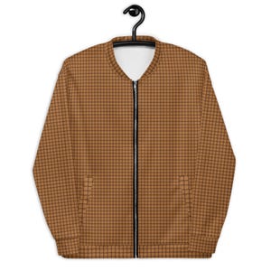 May include: A brown bomber jacket with a black zipper and a checkered pattern.