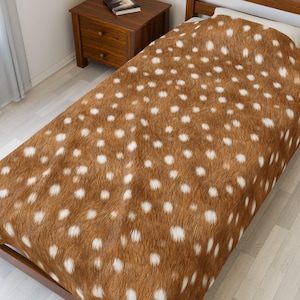 May include: A brown and white spotted bedspread, resembling deer fur, covers a bed. The bedding has a repeating pattern of white spots on a brown background. The bed is made of wood and is in a bedroom setting.