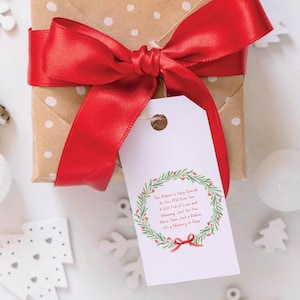 May include: A white gift tag with a green wreath and red berries. The tag has the text "This Ribbon is Very Special As You Will Soon See A Gift Full of Love and Meaning Just for You More Than Just a Ribbon It's a Memory to Keep".