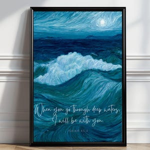 May include: A framed wall art print featuring an oil painting style depiction of a turbulent ocean with deep blue and teal waves under a moonlit sky. The text "When you go through deep waters, I will be with you. ISAIAH 43:2" is printed in white.
