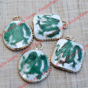 May include: Four green and white porcelain dragon pendants with gold trim. Each pendant features a different dragon design.