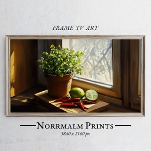 May include: A still life painting of a potted plant with green leaves, red chili peppers, and limes on a wooden cutting board. The painting is set in a kitchen window with natural light streaming in.