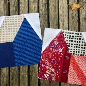 May include: Two unfinished quilt blocks, one in blue and white fabrics and the other in red, white, and black fabrics. Both blocks have a white triangle in the upper corner.