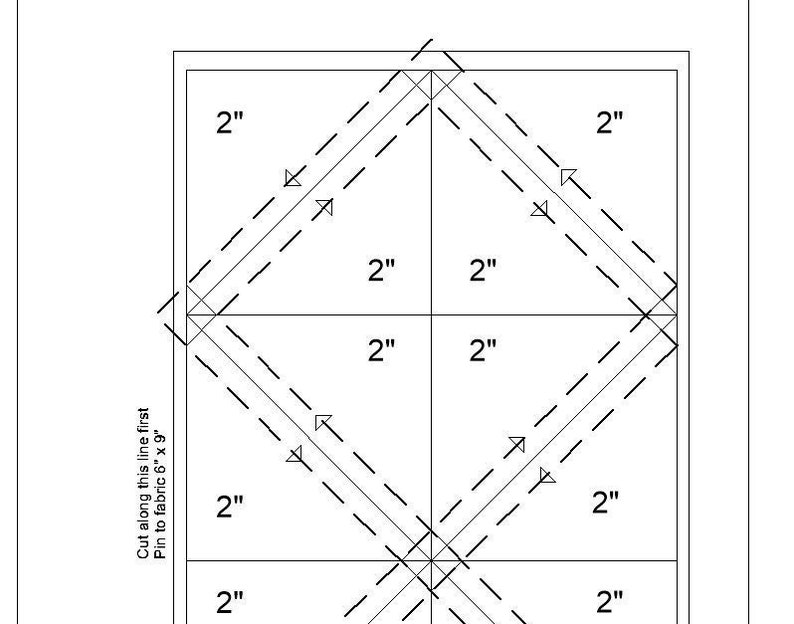 May include: A black and white diagram showing how to cut a 6x9 inch piece of fabric into 2 inch squares. The diagram includes dashed lines and arrows to show where to cut and fold the fabric.
