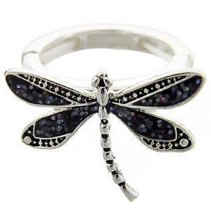 May include: A silver ring with a black dragonfly design. The dragonfly has iridescent wings and a detailed body.