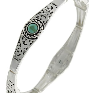 May include: Silver tone stretch bracelet with turquoise stones and an intricate filigree design.