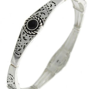 May include: A silver bracelet featuring an intricate design and black stones. The bracelet is expandable and has a delicate, feminine look.