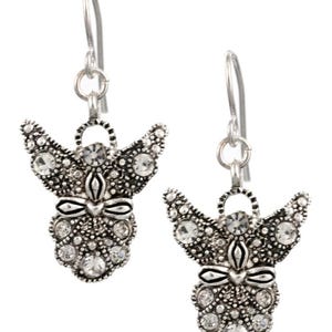 May include: A pair of silver dangle earrings featuring a detailed angel design with clear crystal accents.