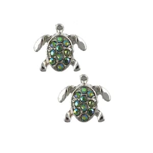 May include: A pair of silver turtle stud earrings with iridescent green rhinestones.