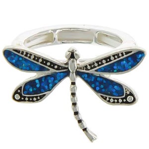 May include: A silver ring with a blue dragonfly design. The dragonfly's wings are detailed with black accents and have a sparkly finish.