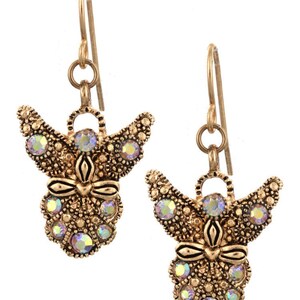 May include: A pair of gold-tone angel dangle earrings with iridescent crystal accents.