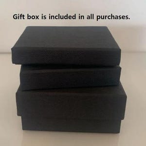 May include: Three black gift boxes stacked on top of each other.  Gift box is included in all purchases.