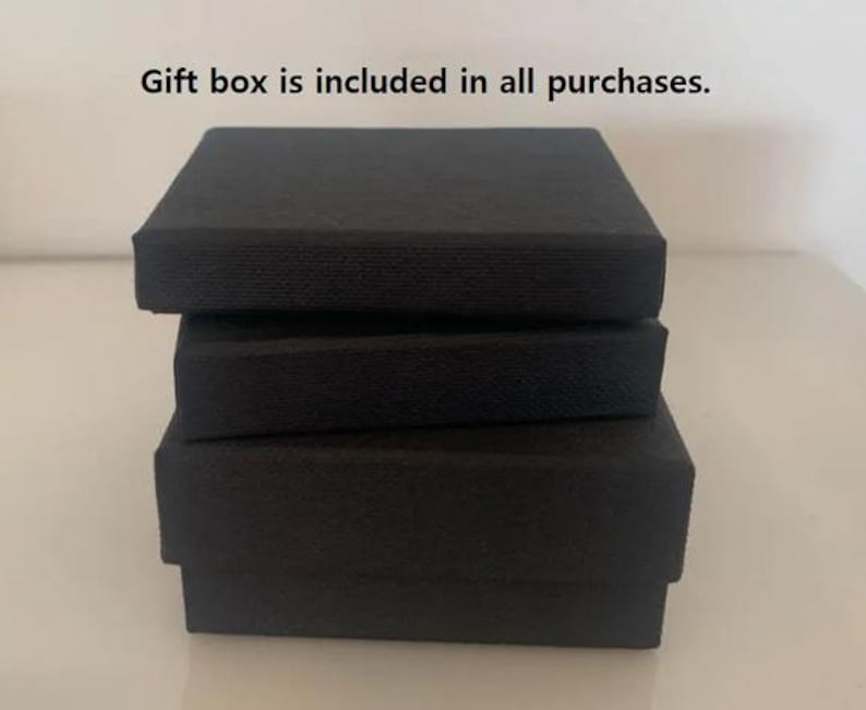 May include: Three black gift boxes stacked on top of each other.  Gift box is included in all purchases.