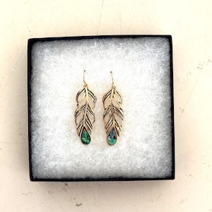 May include: A white ceramic mug with a black handle and the text "But First, Coffee" in a black, bold font. The mug is on a white surface.