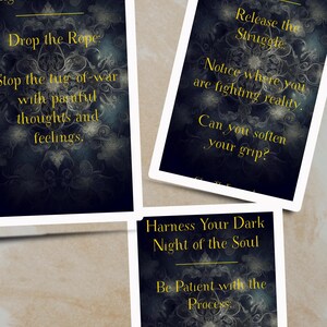 May include: Three cards with a dark blue background and gold text. Each card has the title "Harness Your Dark Night of the Soul" and a different quote about navigating difficult times. The first card says "Drop the Rope: Stop the tug-of-war with painful thoughts and feelings.", the second card says "Release the Struggle: Notice where you are fighting reality. Can you soften your grip?", and the third card says "Be Patient with the Process: Deep shifts take time. Honor your own."