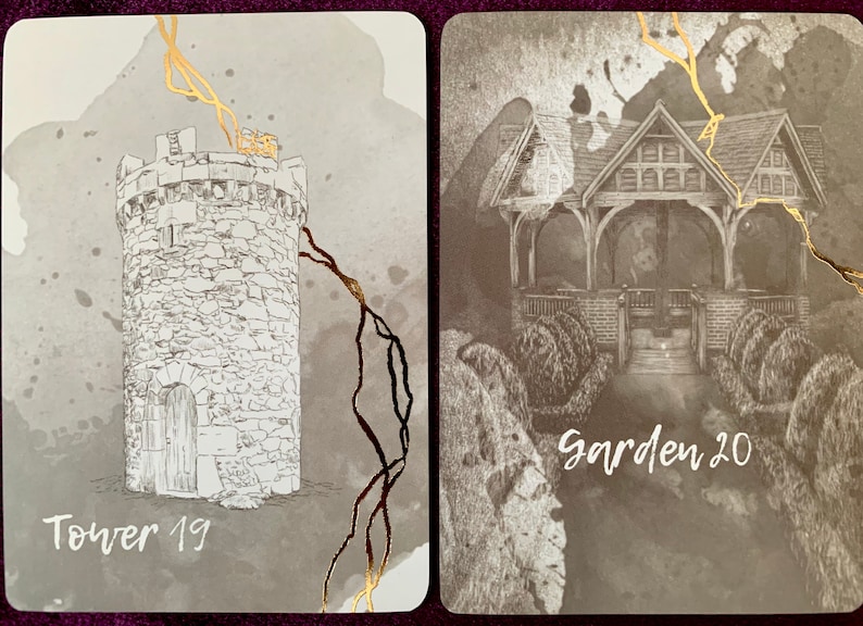 May include: Two tarot cards with gold accents. The card on the left depicts a stone tower with a door and the text "Tower 19". The card on the right shows a wooden gazebo with the text "Garden 20".