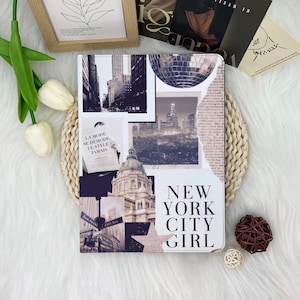 May include: A white and black notebook with a collage design featuring New York City imagery, including cityscapes, a disco ball, and the text "NEW YORK CITY GIRL". The notebook is surrounded by decorative elements.
