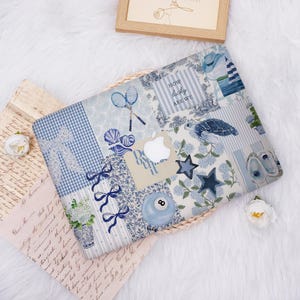 May include: A blue and white patterned laptop case with various designs, including tennis rackets, bows, and a turtle. The case features the Apple logo and the text "Do it" and "How lucky are we".