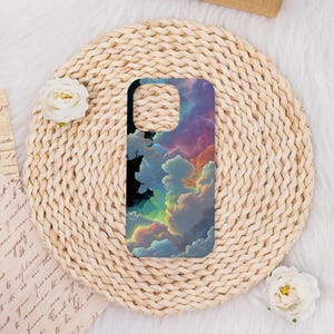 May include: A smartphone case featuring a vibrant, colorful cloudscape design. The case showcases a blend of blues, pinks, purples, and yellows, creating a dreamy, artistic aesthetic. The case is set against a woven, circular background.