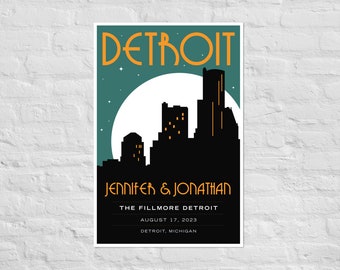 May include: A teal blue poster with a black silhouette of the Detroit skyline. The text "DETROIT" is in orange at the top of the poster. The text "Jennifer & Jonathan" is in orange at the bottom of the poster. The text "The Fillmore Detroit" is in black below the names. The text "August 17, 2023" is in black below the venue. The text "Detroit, Michigan" is in black below the date.