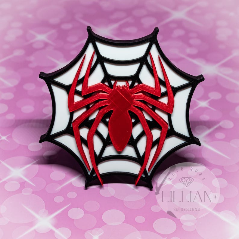 May include: A red spider silhouette on a white web with a black outline. The web is in the shape of a star. The spider is in the center of the web.