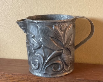 Vintage rustic pewter creamer with botanical design