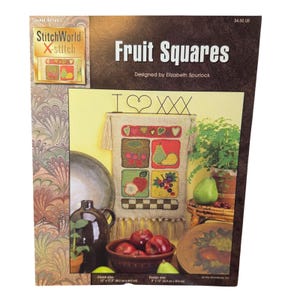 May include: A cross-stitch pattern titled "Fruit Squares" by Elizabeth Spurlock. The design features a sampler with squares of stitched fruit, including cherries, pears, apples, and grapes. The finished size is 12" x 17.5" (30.5 cm x 44.5 cm).