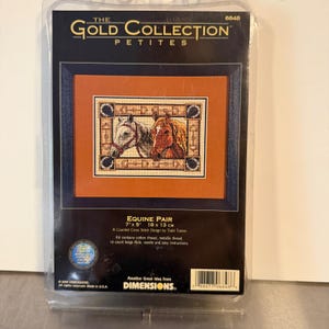 May include: A Dimensions The Gold Collection Petites Equine Pair counted cross stitch kit in a plastic package. The kit features a design of two horses, one white and one brown, within a rectangular frame. It measures 7 inches by 5 inches.