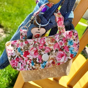 Tiny bag that hooks onto backpack or purse.