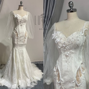 Custom Ivory Mermaid Wedding Dress In Premium Floral Lace Fabric With Romantic Tulle Puff Sleeves And Figure-Flattering Cutout At The Waist