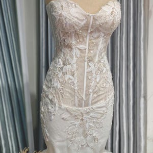 Custom Ivory Mermaid Wedding Dress In Premium Floral Lace Fabric With Romantic Tulle Puff Sleeves And Figure-Flattering Cutout At The Waist