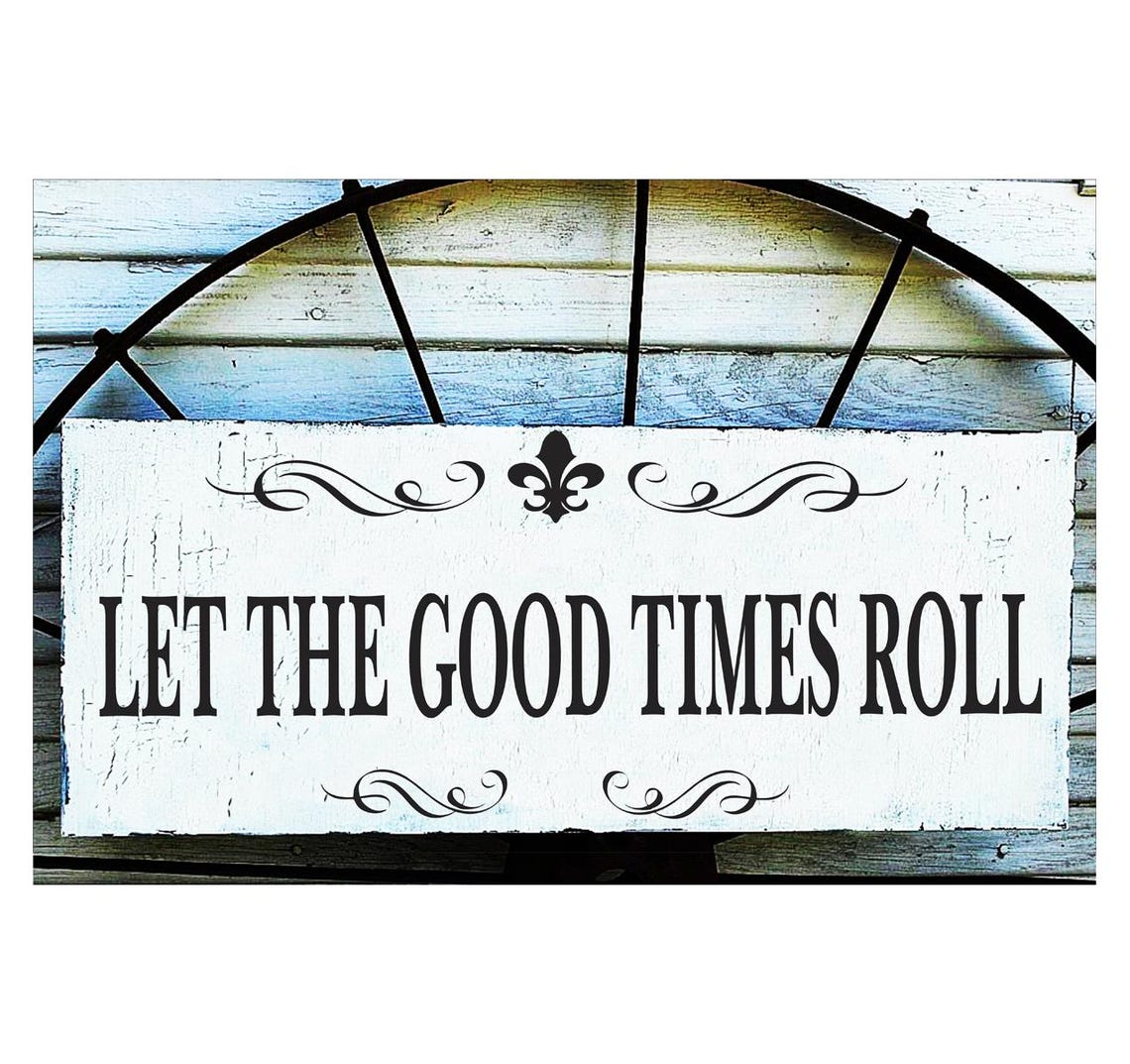 May include: A rectangular white wooden sign with the phrase 