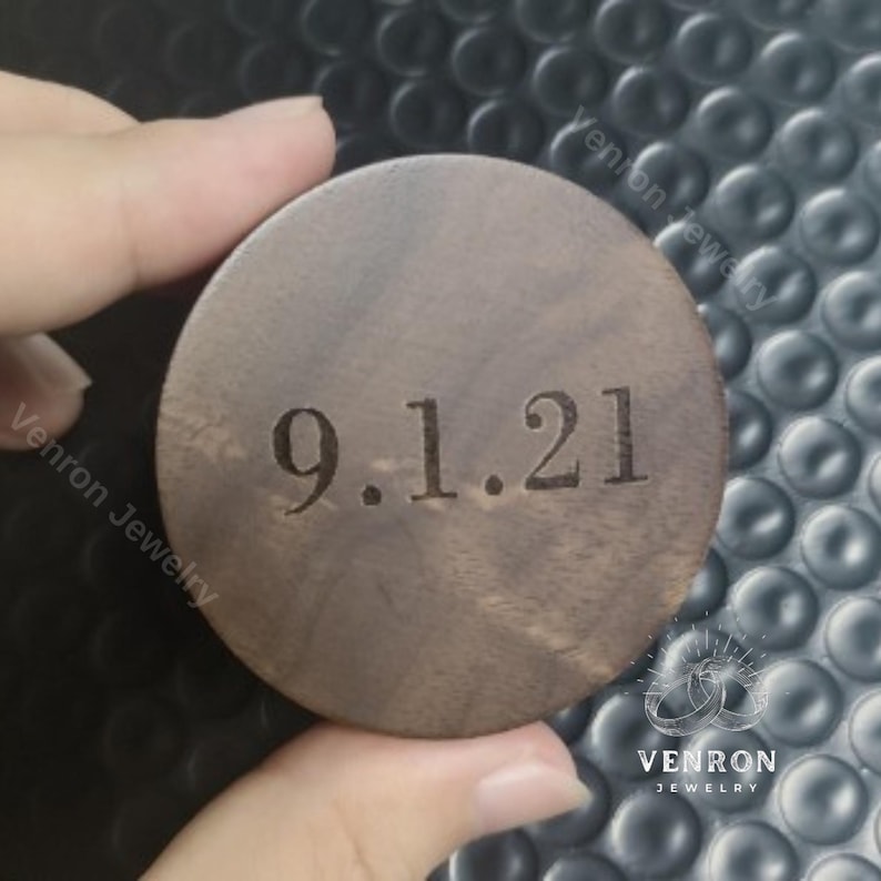 May include: A round, dark brown wooden box with the date 9.1.21 engraved on the top.