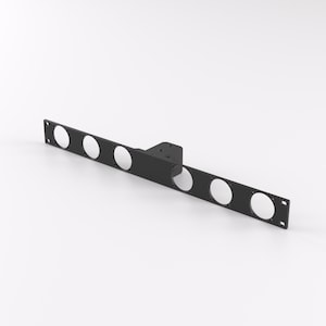 May include: Black metal wall mount with six circular cutouts. The mount is designed to hold a variety of items, such as tools, accessories, or decorations.