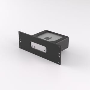 May include: A black metal rack with a silver computer device inside. The computer has an Apple logo on the front.