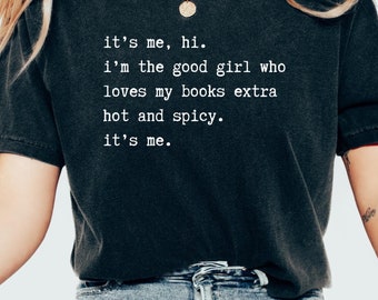 May include: A black t-shirt with white text that reads "it's me, hi. i'm the good girl who loves my books extra hot and spicy. it's me."