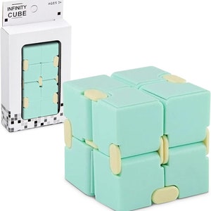 May include: A mint green Infinity Cube toy with cream-coloured connectors. The cube is shown assembled and in its packaging, which displays the text "INFINITY CUBE" and "AGES 3+".