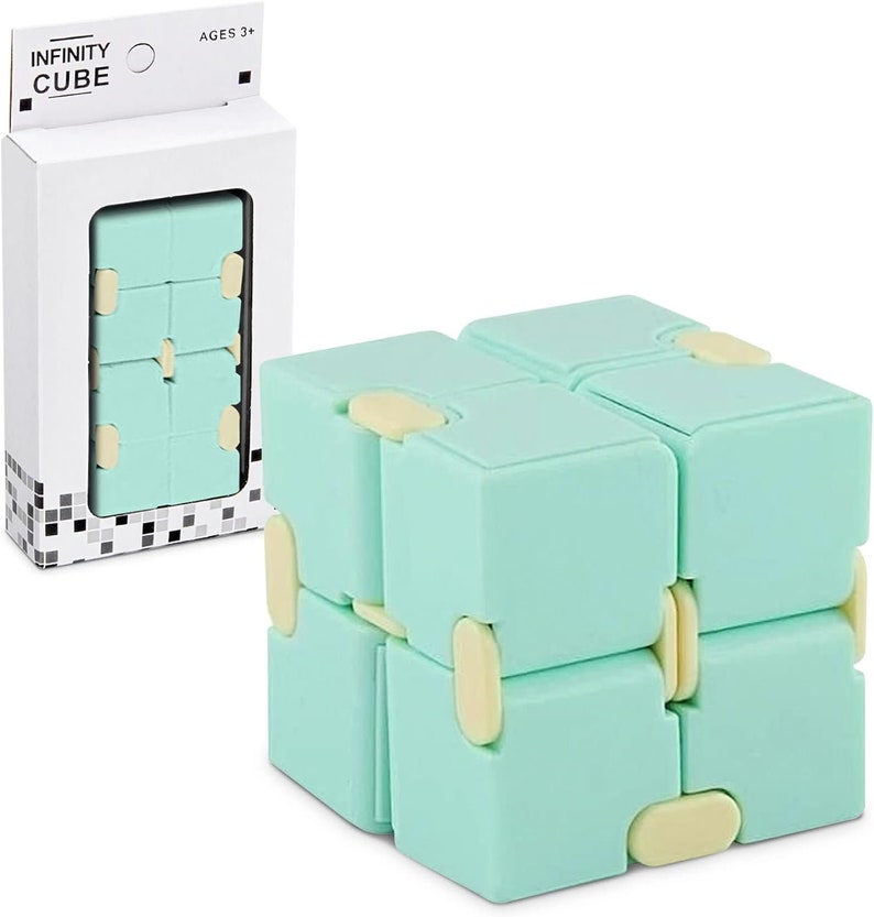 May include: A mint green Infinity Cube toy with cream-coloured connectors. The cube is shown assembled and in its packaging, which displays the text "INFINITY CUBE" and "AGES 3+".