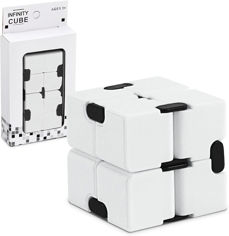 May include: A white Infinity Cube toy with black details, shown in its box. The packaging displays the words "INFINITY CUBE" and "AGES 3+". The cube is made of interconnected blocks that can be manipulated.