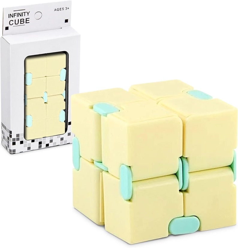 May include: A yellow and light blue Infinity Cube toy. The cube is made of eight connected blocks that can be folded and manipulated. The packaging reads "INFINITY CUBE" and "AGES 3+".