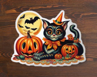 May include: A Halloween-themed sticker featuring a black cat wearing a witch's hat and an orange bow. The cat is surrounded by pumpkins, bats, and a full moon. The sticker has a white border and a decorative edge.